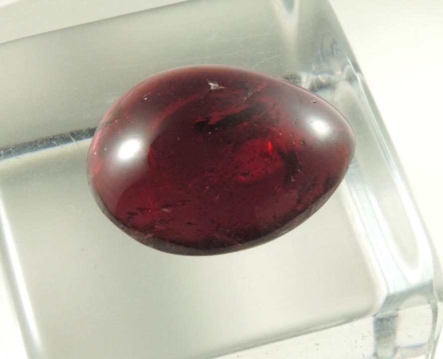 Detail view of mineral Almandine Garnet (polished cabochon) for sale from 65th Street at Columbus Avenue, Manhattan Island, New York City, New York County, New York